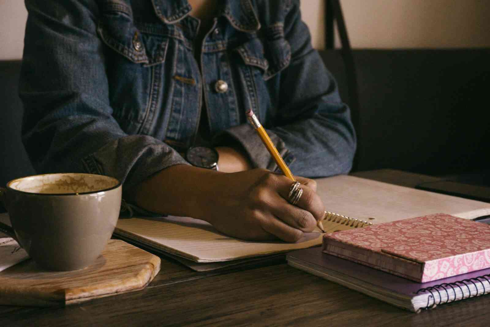 Write for the Ability Toolbox. Image: African-American woman writing in notebook.