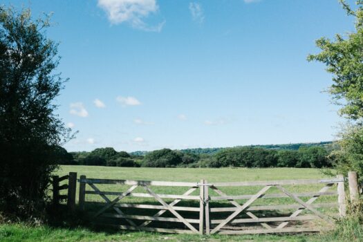 Mental health boundaries represented by a fence in the countryside.