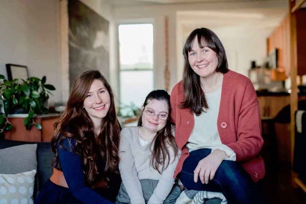 Dance Happy Designs, a design business owned by a woman with Down syndrome and her two friends. Dance Happy Design's co-owners (left to right): Emily Scott, Julia Tyler, and Liv Helgesen.