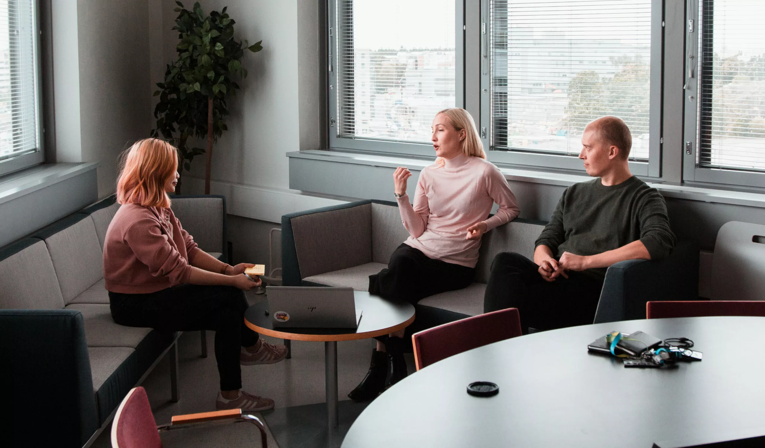 Therapist doing counseling with a man and woman in her office.