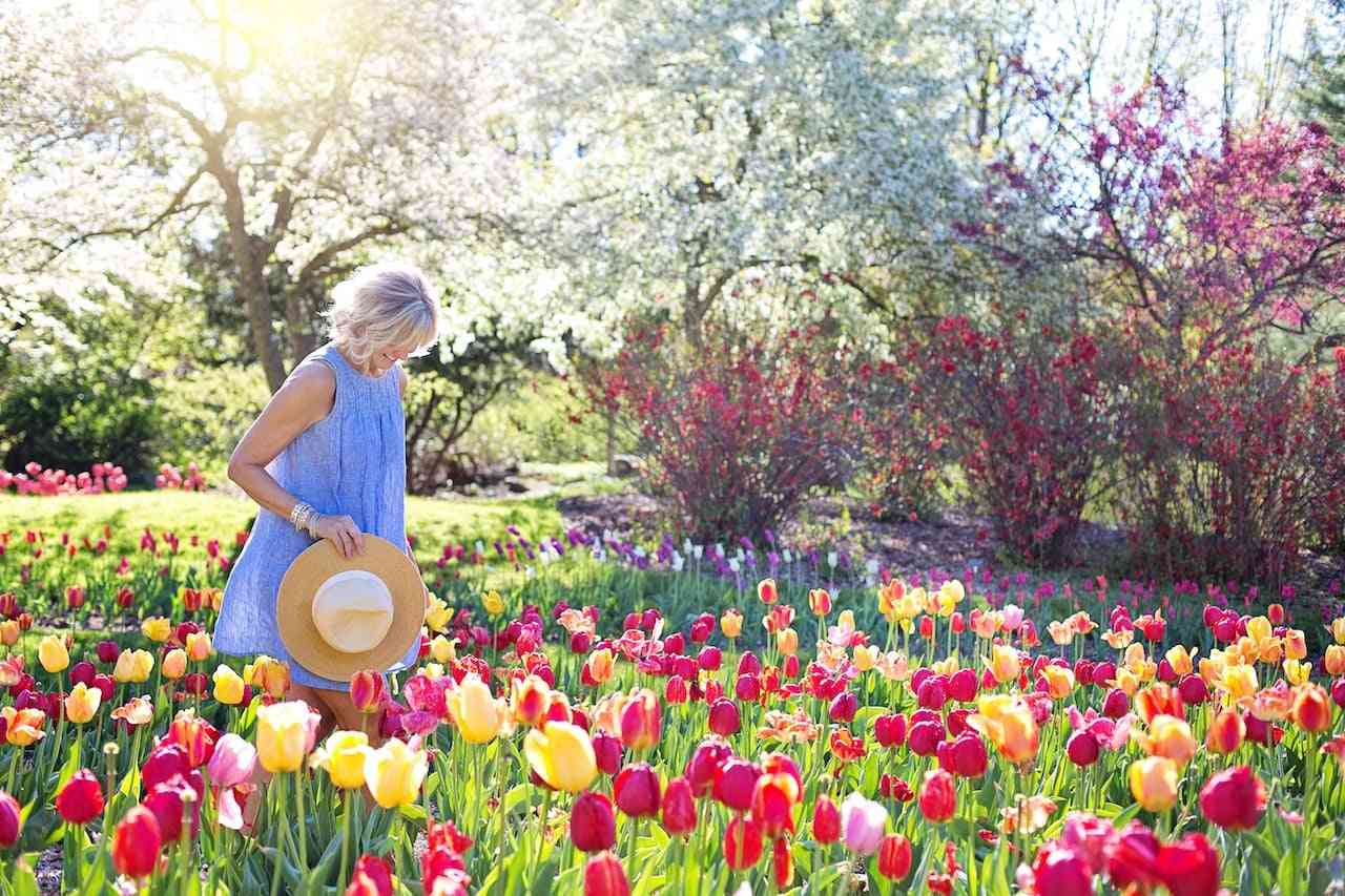 Coping with dyspraxia and sensory processing issues. Woman walking through a field of tulips.