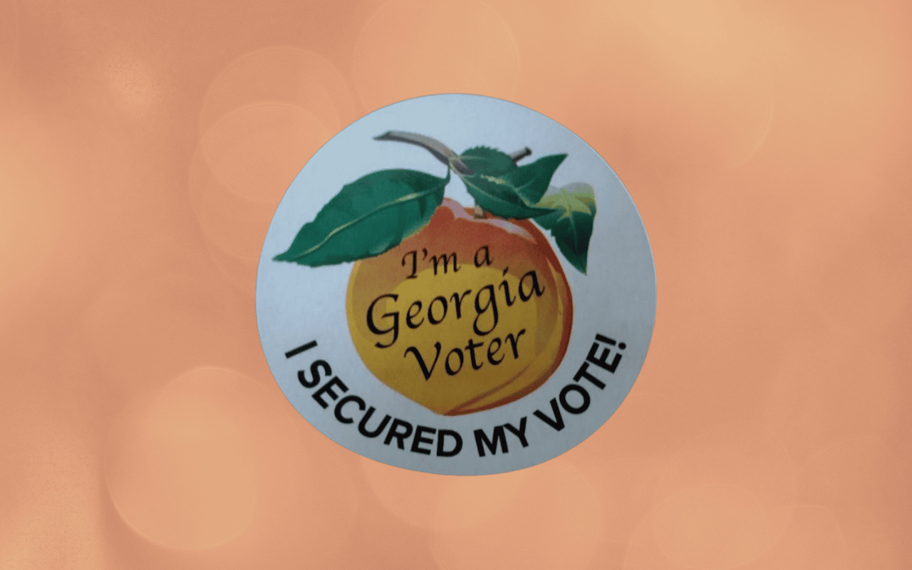 Voting sticker from Georgia with a peach. People with disabilities face barriers to voting in the United States.