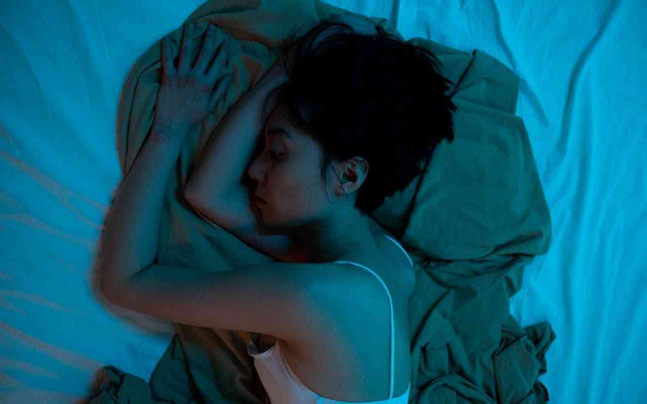 How sleep affects mental health. Woman in bed trying to sleep.