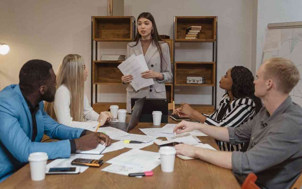 Leadership and mental health. A woman manager speaking to her team at work.