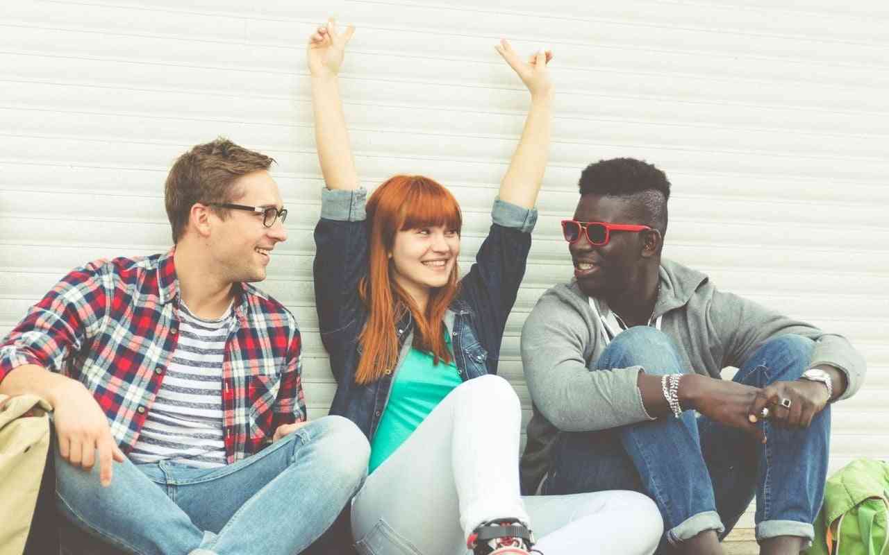 How to support your autistic loved one. Friends sitting together laughing.