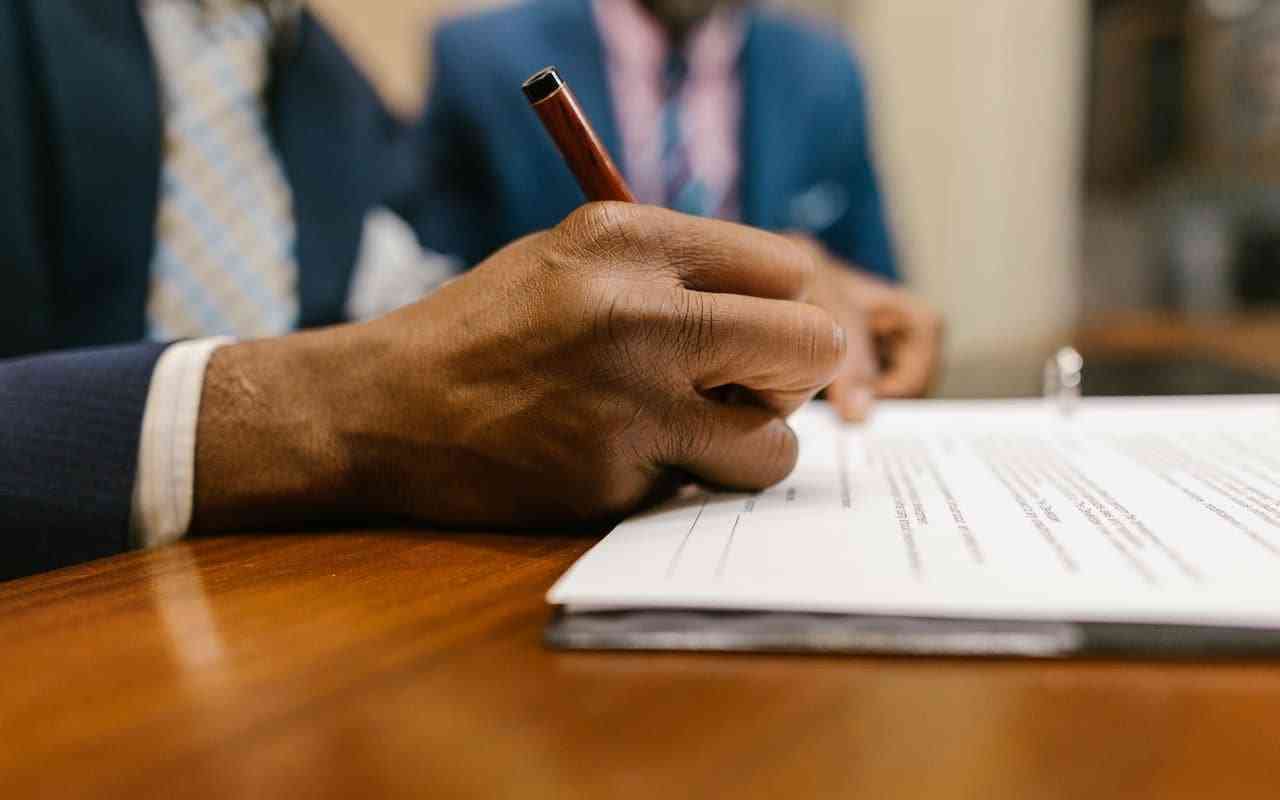 Man filling out application for disability benefits for PTSD.