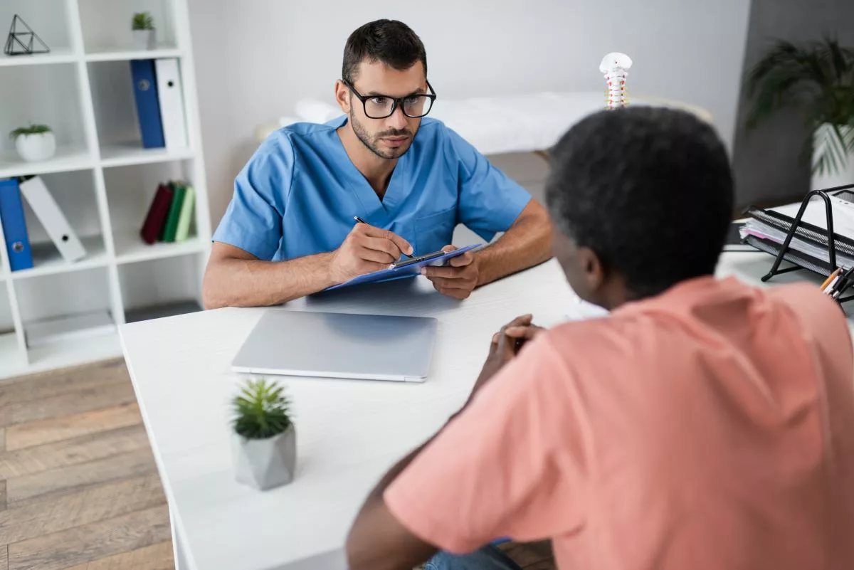 Man consulting nurse at a medical detox center.