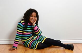 African American girl wearing striped dress.
