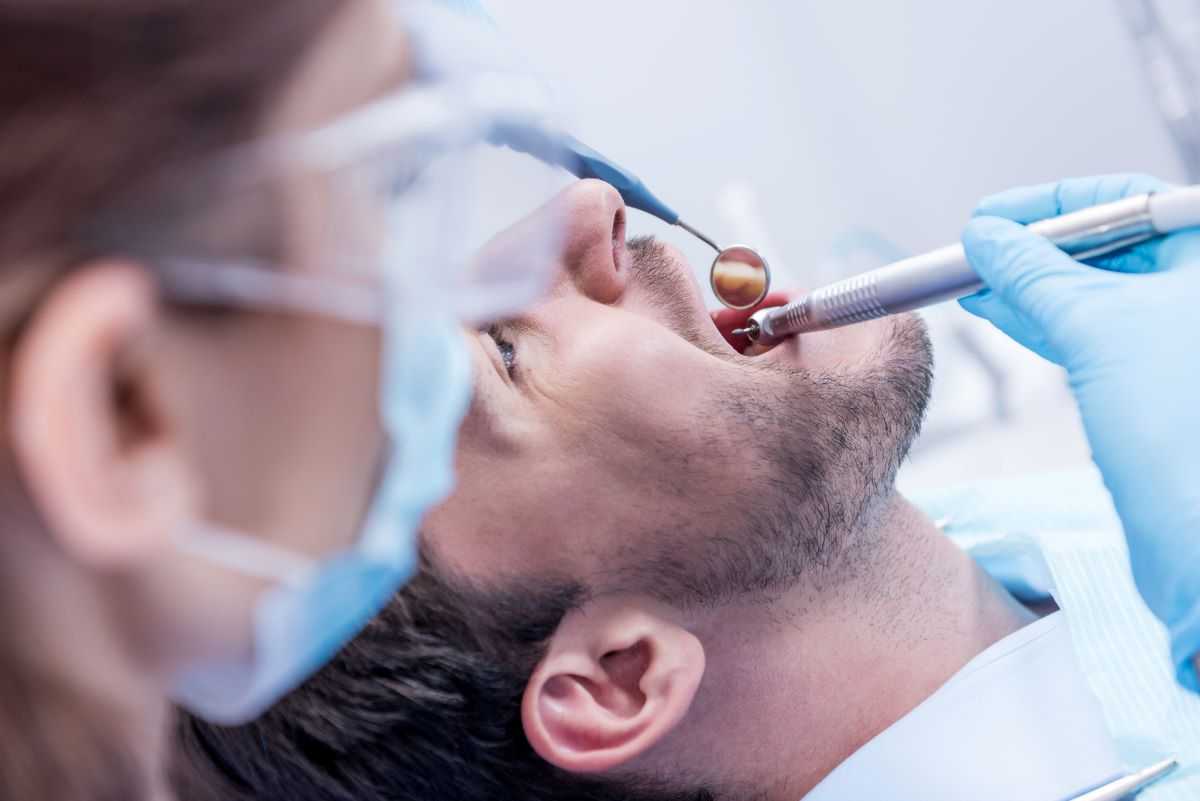 Man at the dentist for a tooth extraction.