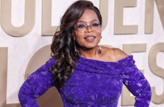 Oprah Winfrey wearing a purple designer gown.