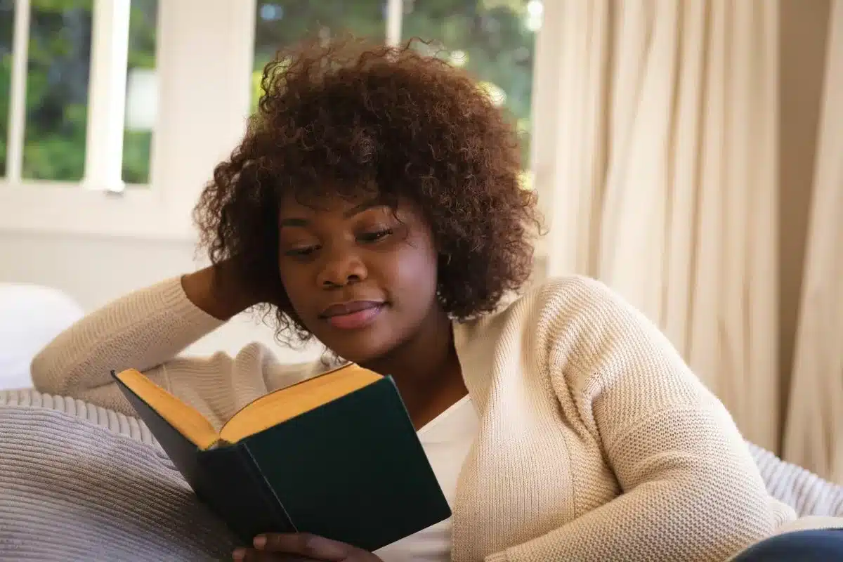 Woman reading a novel in which a character lives with mental illness.