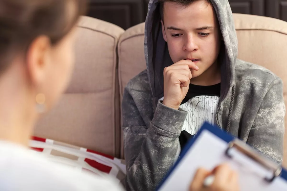 Teen boy meeting with a mental health professional.