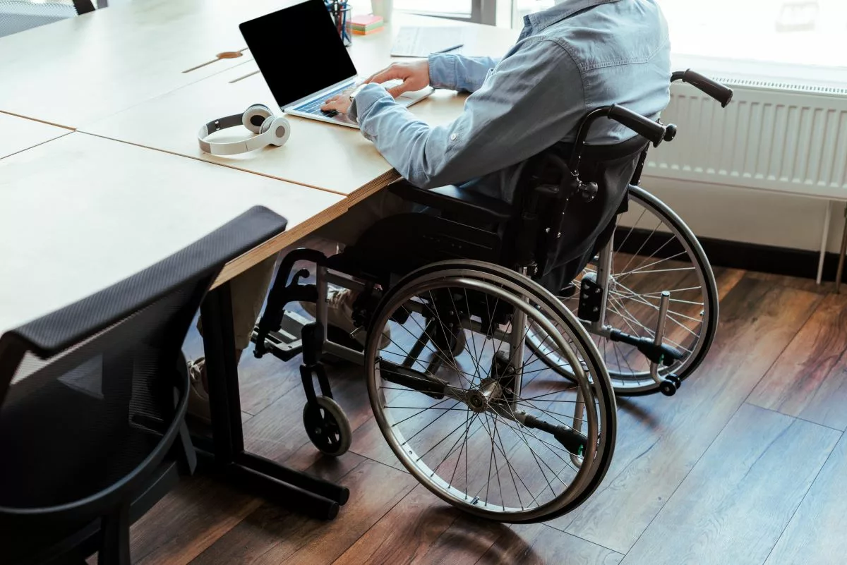 Man in wheelchair at work.