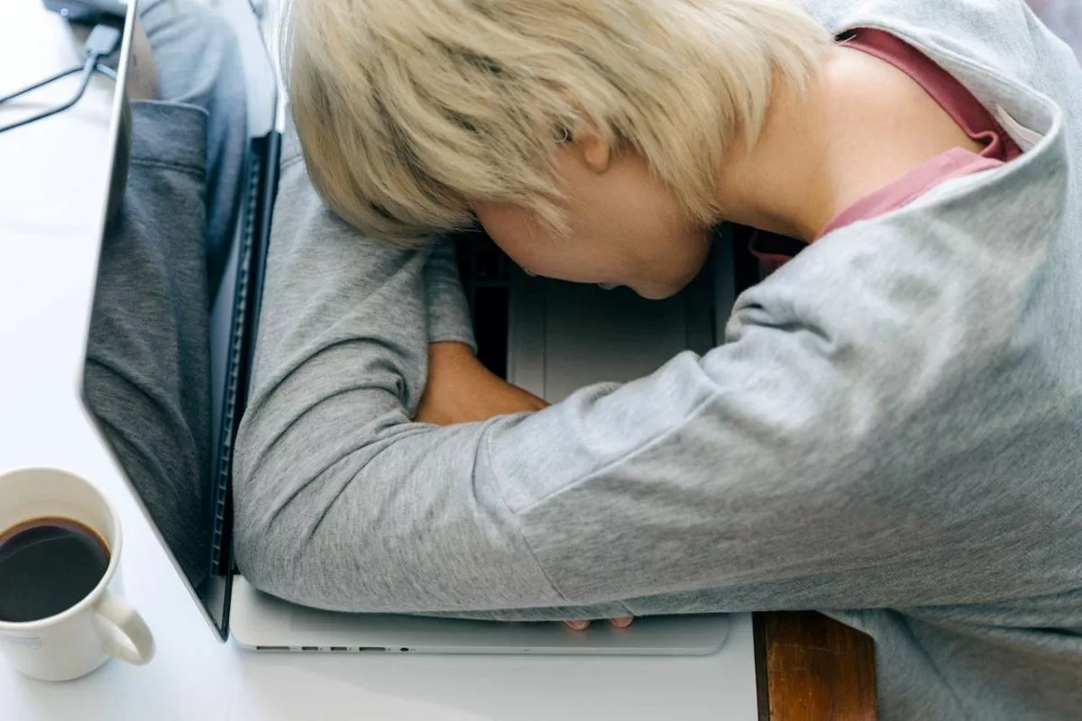 Person falling asleep at computer.