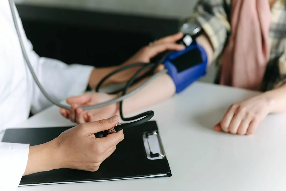 Nurse taking patient's blood pressure.