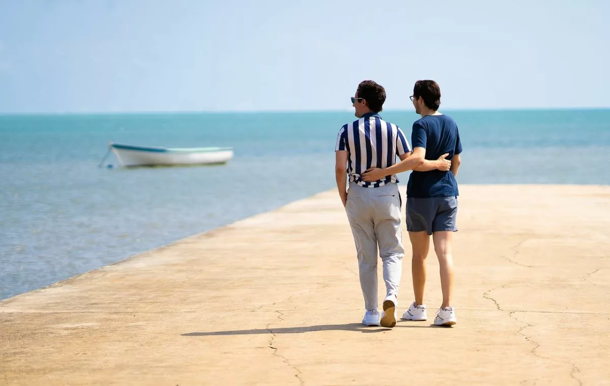 Couple walking on beach.