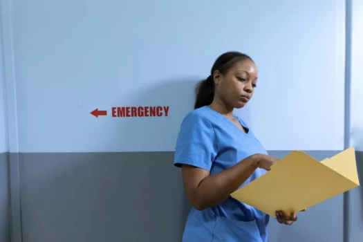 Nurse studying a patient chart.