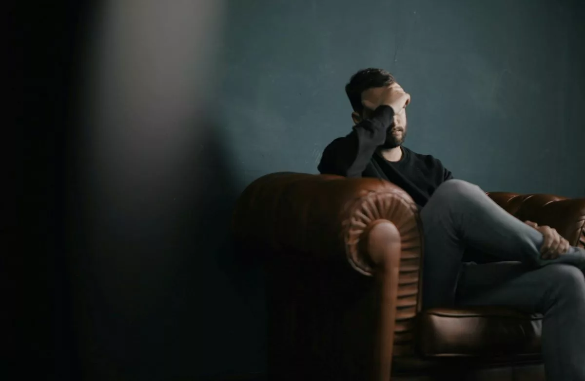 Stressed man sitting in armchair.