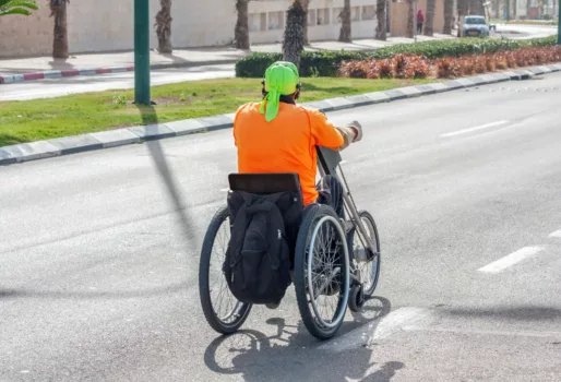 Disabled vacationer using a hand cycle.