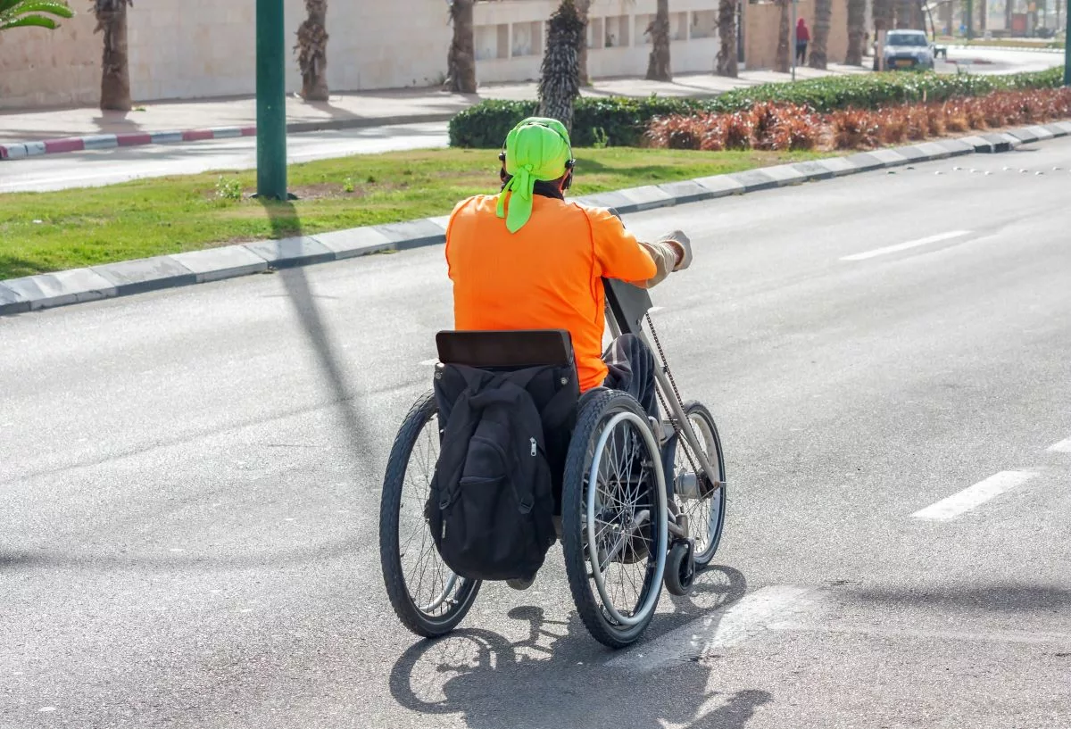 Disabled vacationer using a hand cycle.