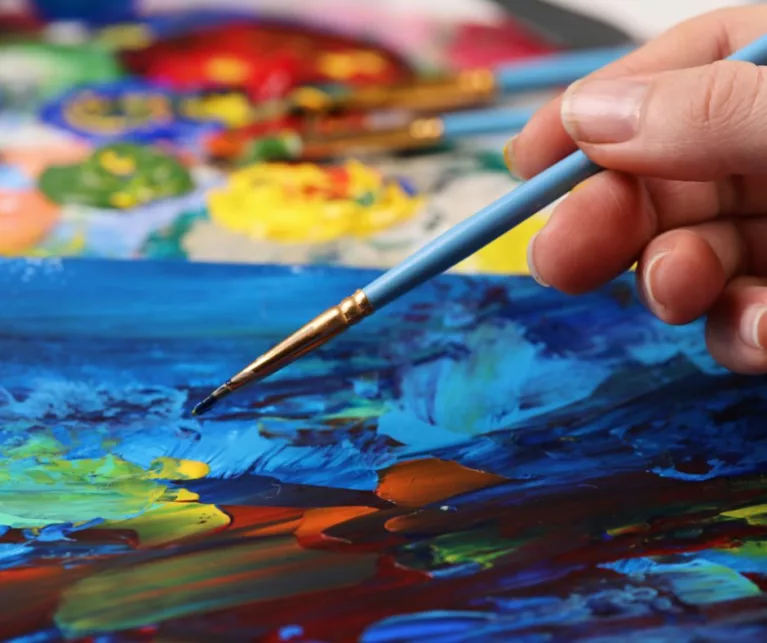 Person creating abstract painting