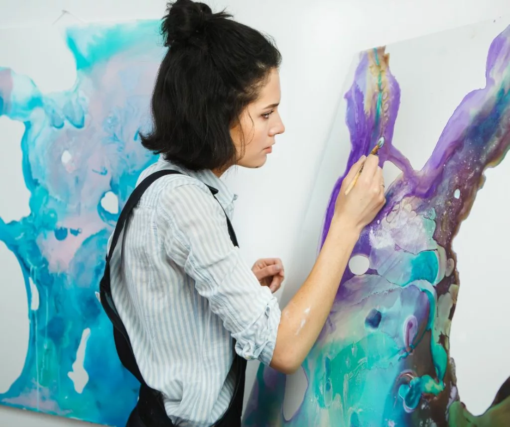 Woman painting during art therapy.