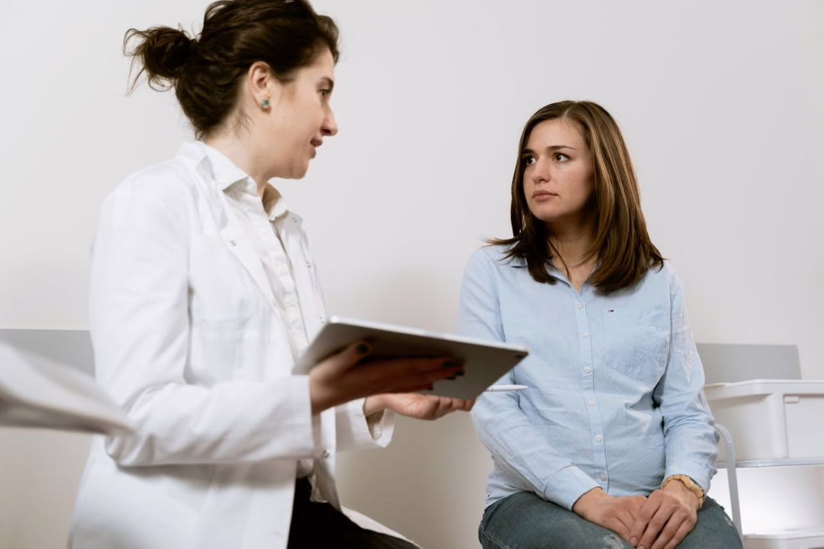 Nurse with patient reviewing information on a tablet.