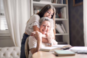 Grandchild hugging grandmother.