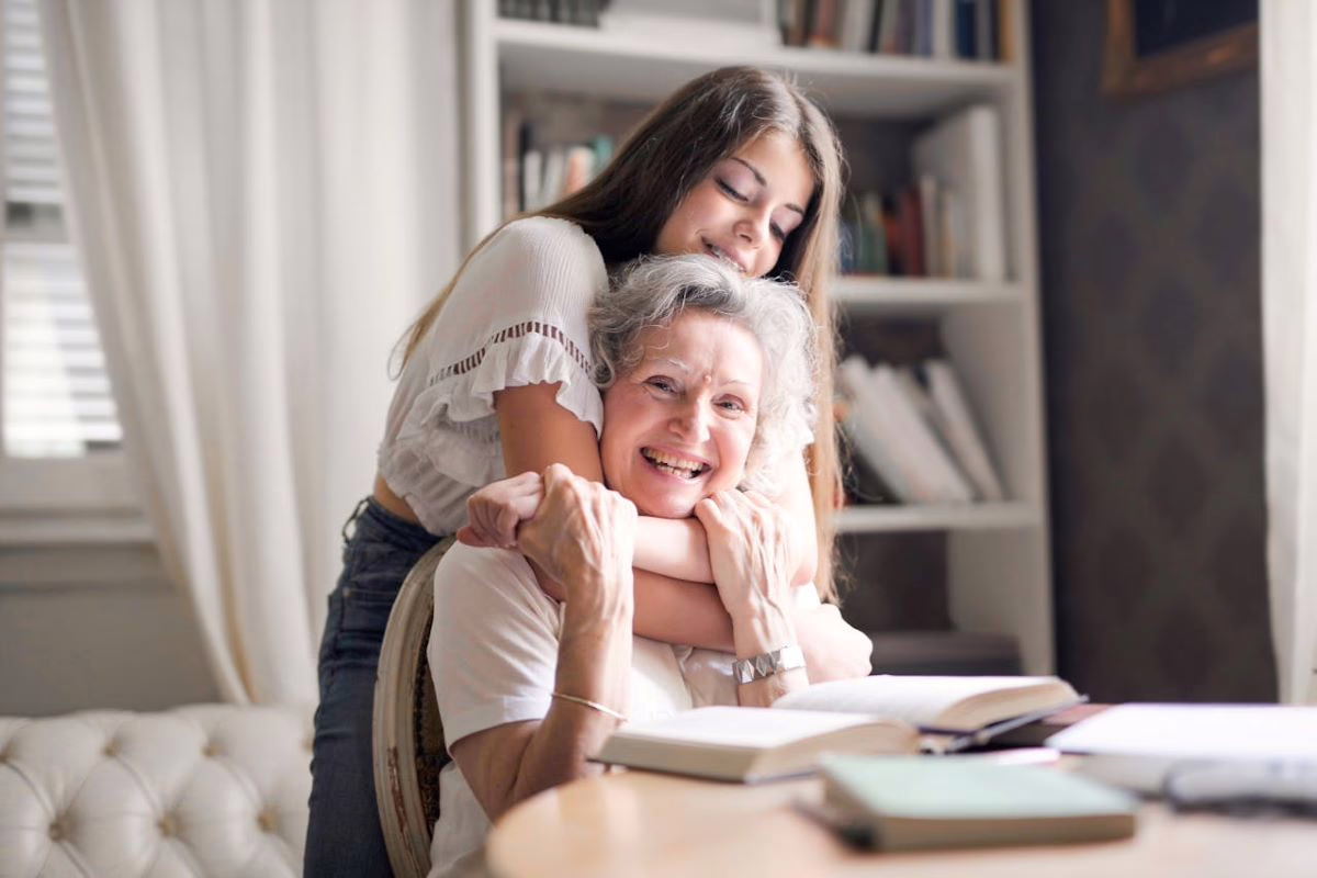 Grandchild hugging grandmother.