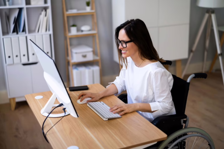 Woman in wheelchair studying at computer.