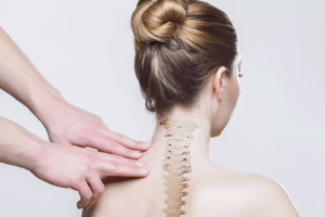 Doctor examining woman with scoliosis.