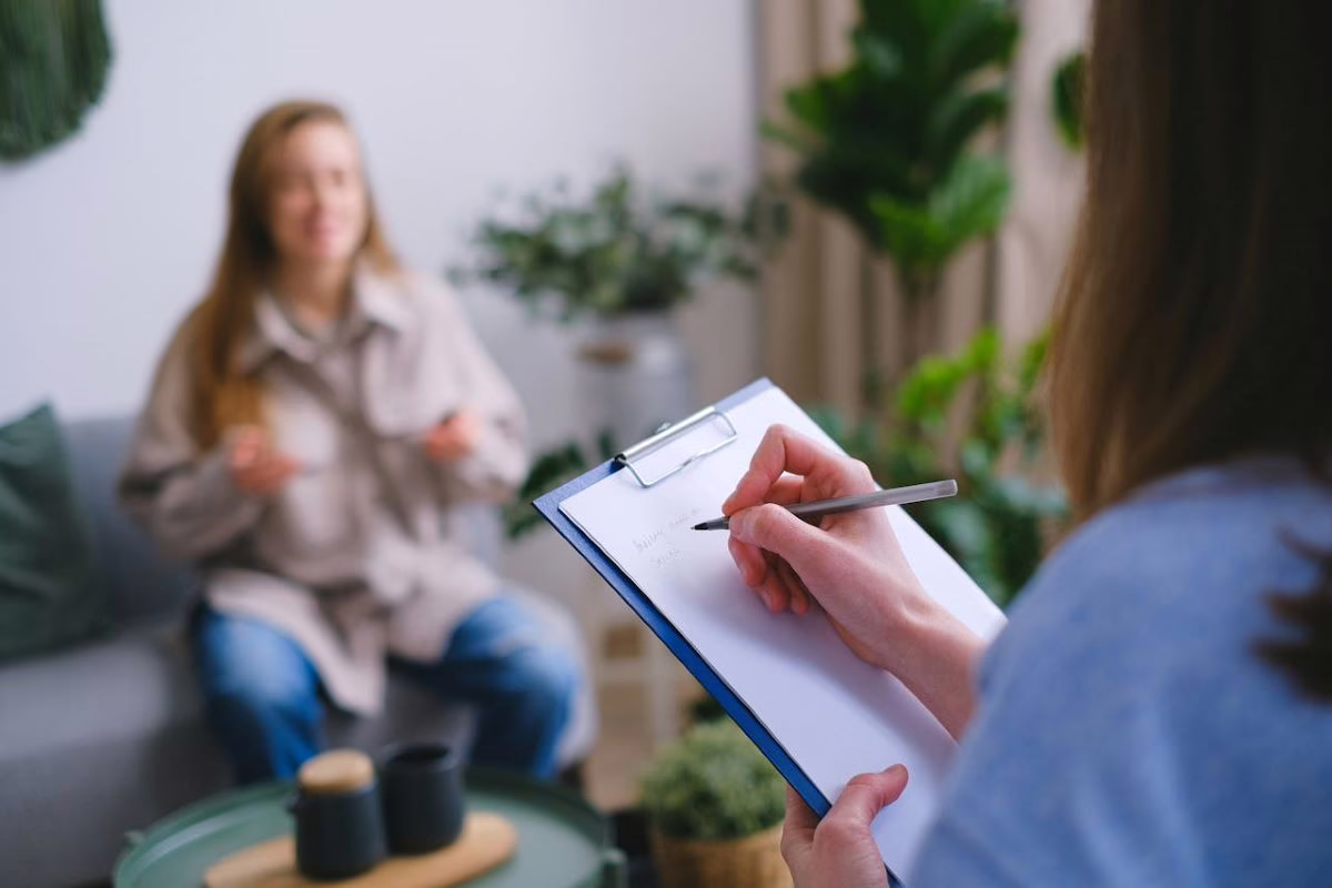 Therapist taking notes during a session.