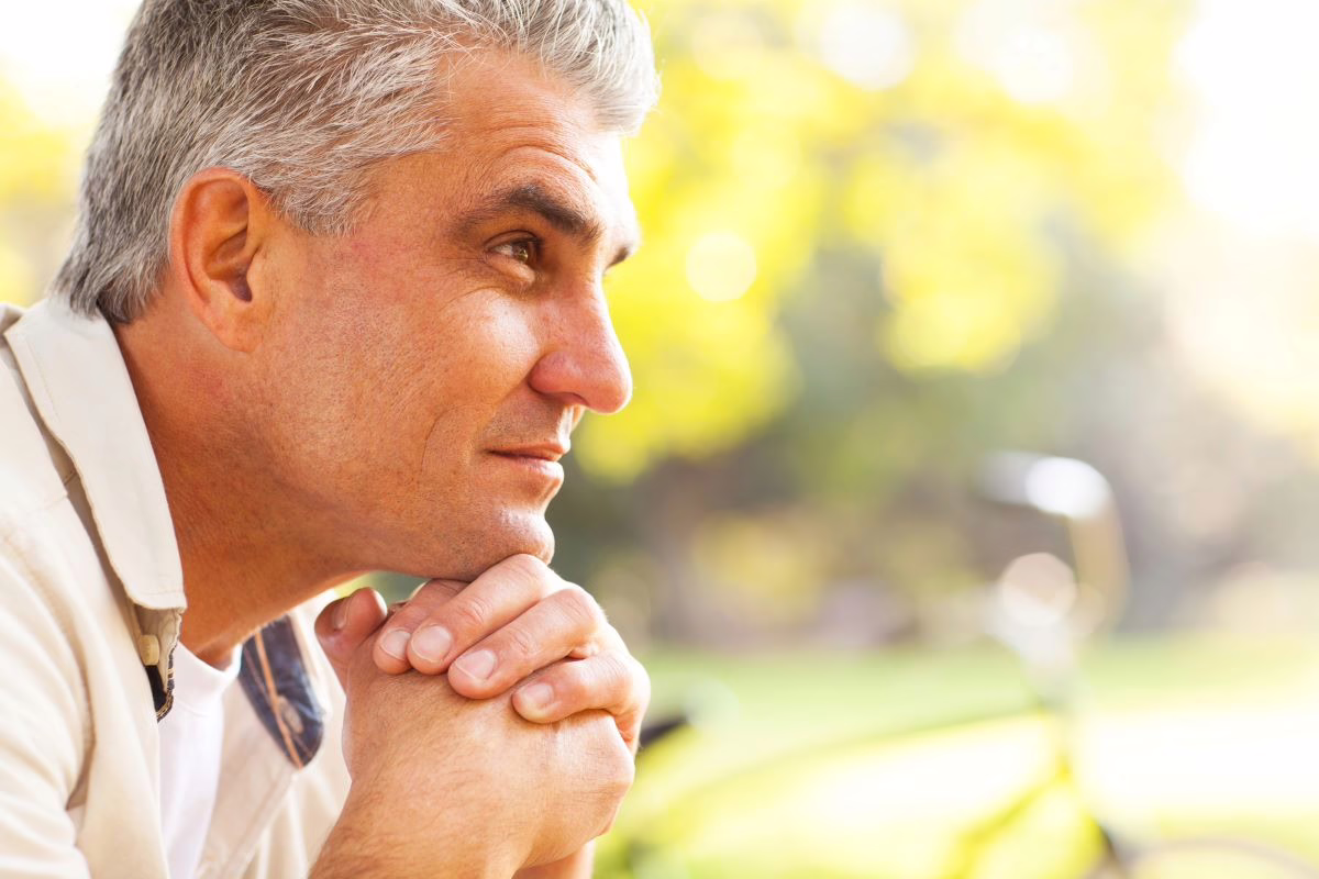 Man sitting outside thinking.