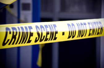 Surviving a home invasion robbery as a person with a disability. Crime scene tape outside a building.