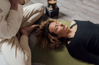 Woman meditating on a mat.