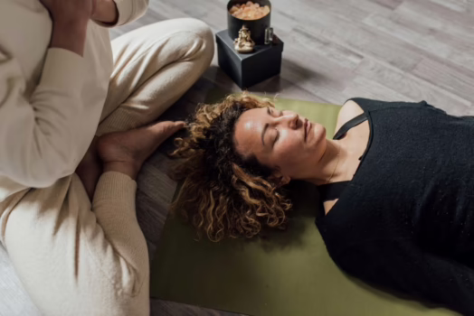 Woman meditating on a mat.