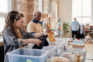 Social workers processing clothing donations.