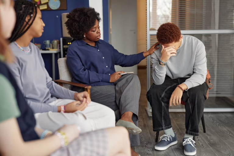 Teen being comforted in recovery support group