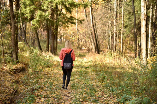 Woman walking in the forest.