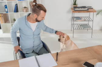 Man in a wheelchair petting his dog.