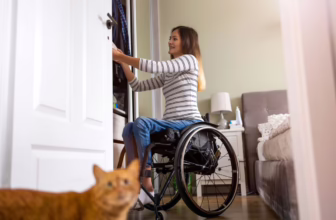 Woman in wheelchair organizing her wardrobe.