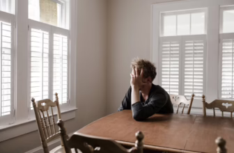 Sad man sitting at table.