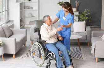 Nurse assisting patient in wheelchair.