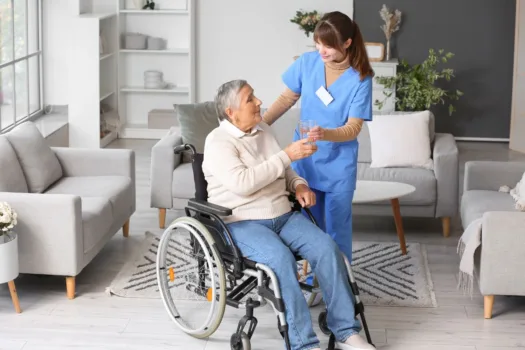 Nurse assisting patient in wheelchair.