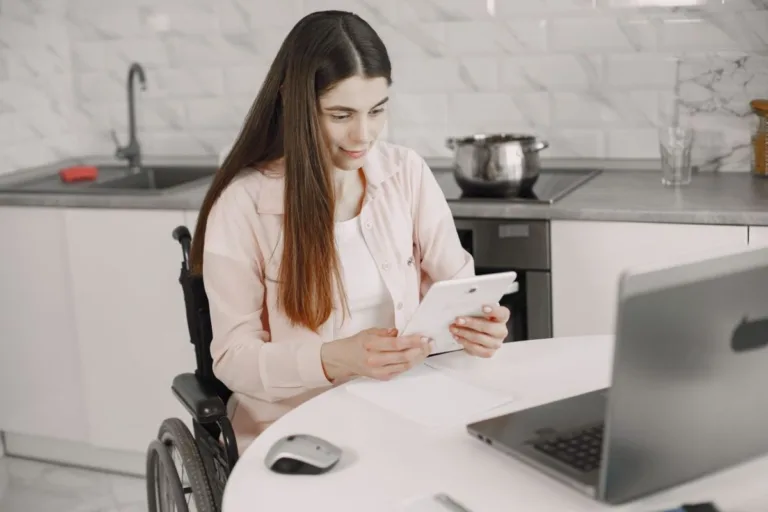 Woman in wheelchair using a tablet.