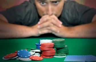 Stressed man looking at poker chips.