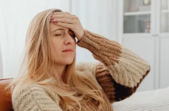 Woman struggling with migraine.