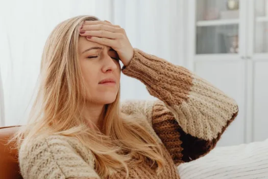 Woman struggling with migraine.