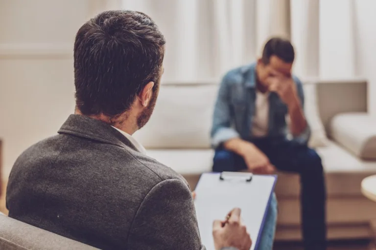 Upset man talking to counselor.