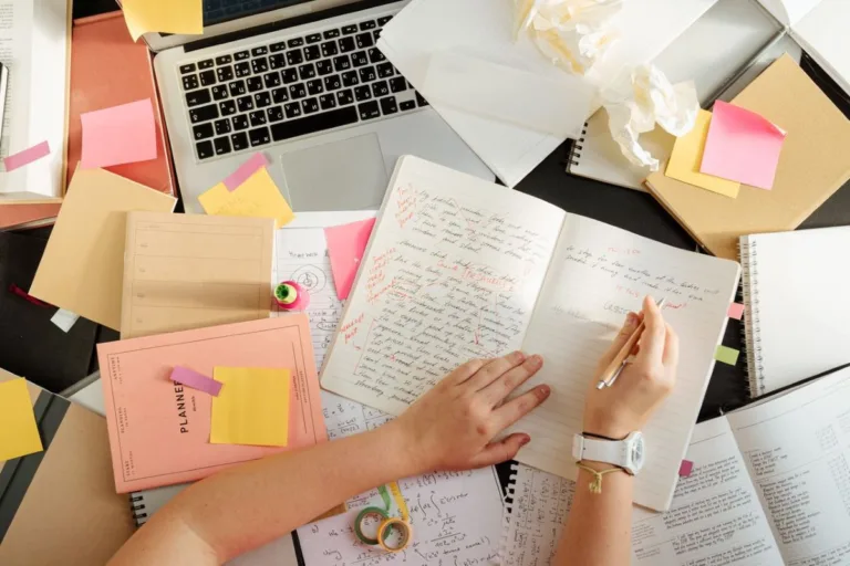 Student with lots of papers.